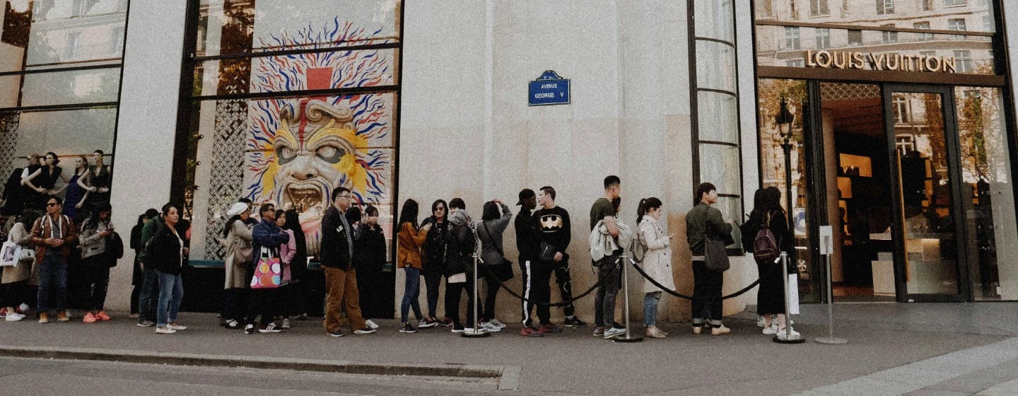 people queuing outside louis vuitton store showing brand loyalty